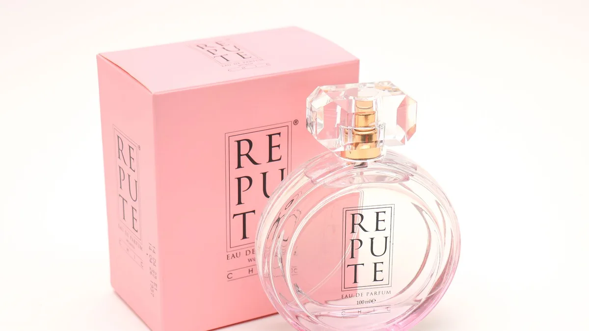 A stylish perfume bottle with pink box displaying elegant fragrance branding.