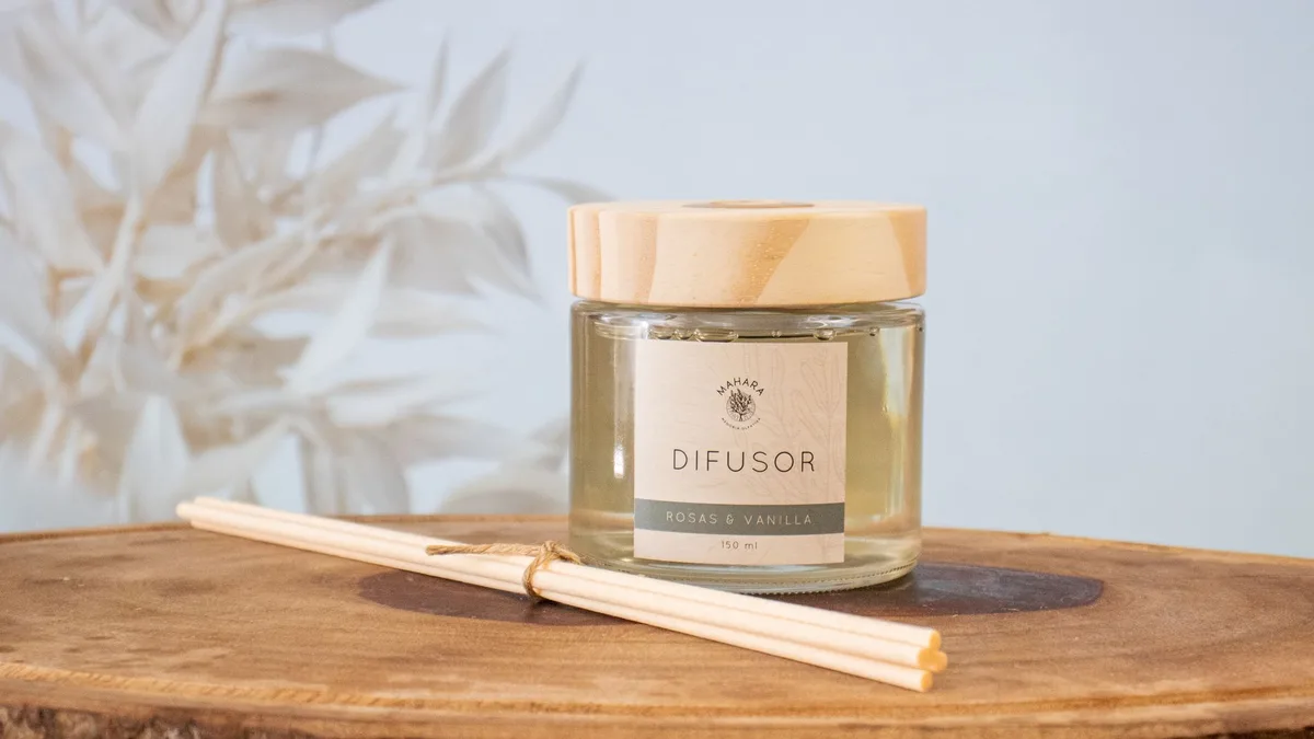 Aesthetic image of a rose and vanilla diffuser on wood, ideal for home decor and aromatherapy themes.